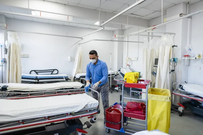 Healthcare worker cleaning hospital ward